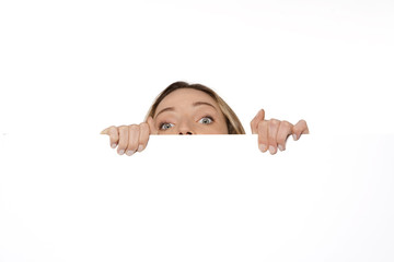 Behind a white board - Woman hiding or peeking behind a white sign