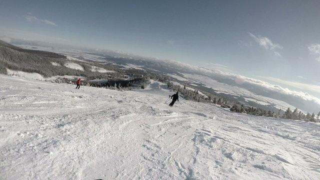 4K High mountain skiing resort: skier goes down the hill