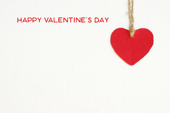 Happy valentine's day and red fabric heart shape 