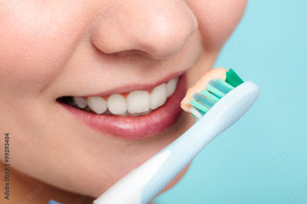 Wall mural woman holds toothbrush with toothpaste cleaning teeth