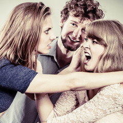 Aggressive mad women fighting over man.