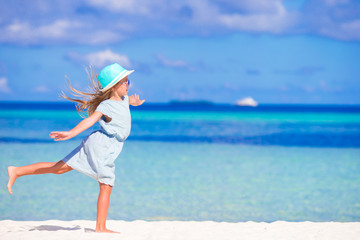 Adorable little girl during beach vacation having fun