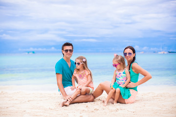 Fototapeta na wymiar Young family of four on beach vacation