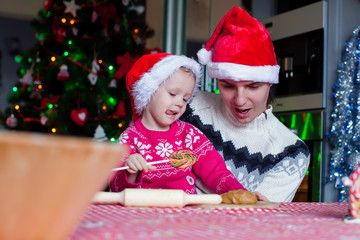 Fototapeta na wymiar Family baking Christmas cookies at home kitchen