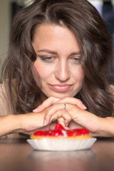 Pretty girl Looking to strawberry cake