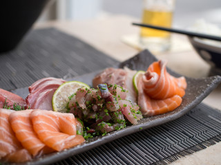 Japanese sashimi on a black dish