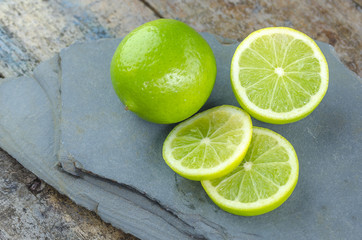 Tahitian limes on a stone background.