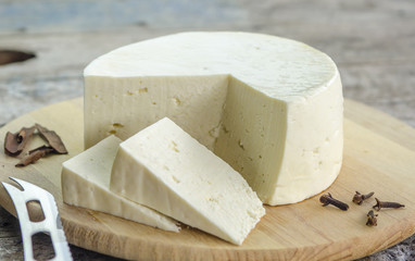 White cheese on a tray on a wooden background