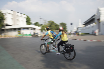 Bikes, two men and a woman blur