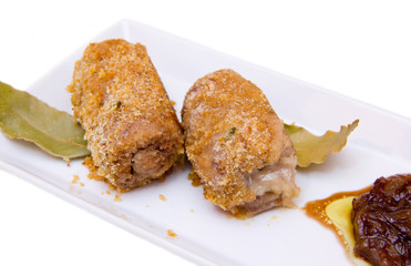Breaded meat rolls on the tray on white background seen up close