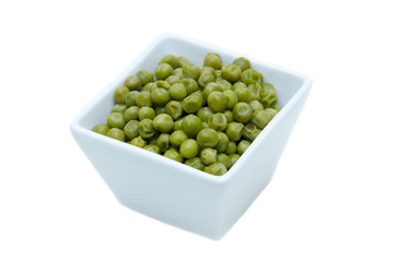 Cooked peas on square bowl on a white background