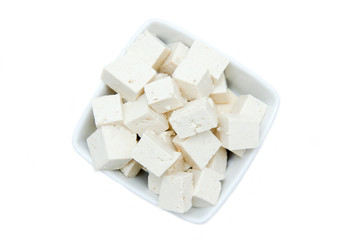 Cubes of tofu square bowl on a white background seen from above