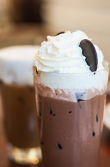 Cafe Latte in a tall class with ice chocolate on background