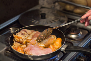 Cooking chicken wings and breasts in the kitchen at home.