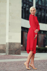 Happy beautiful woman in red summer dress