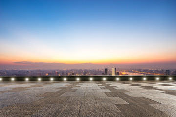 empty floor front of cityscape at sunrise