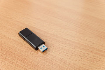 USB flash drives on wooden background.