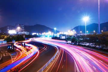 Fototapeta na wymiar traffic on urban road and cityscape at night