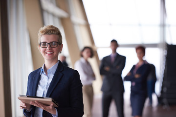 business woman with glasses  at office with tablet  in front  as