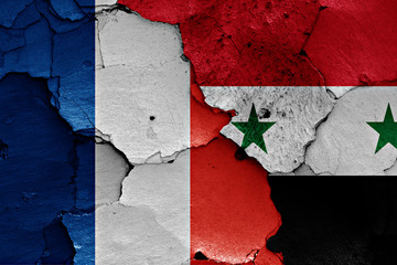 flags of France and Syria painted on cracked wall