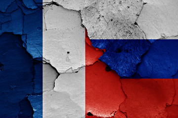 flags of France and Russia painted on cracked wall