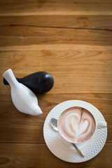Hot art Latte Coffee in a cup on wooden table.