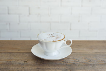 Hot cappuccino on wood background