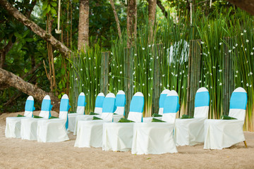 floral arrangements located on seats at a wedding ceremony