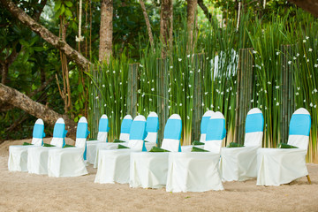 floral arrangements located on seats at a wedding ceremony