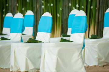 floral arrangements located on seats at a wedding ceremony