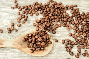 Coffee and spoon on wood table.