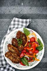 Fish cutlets with a salad, top view