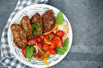 Fish cutlets with tomato, top view