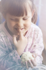 girl licks a finger dough