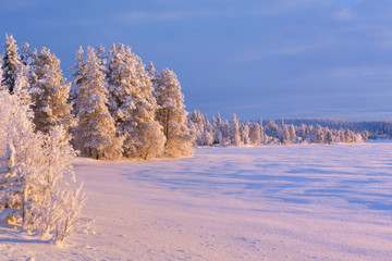 Frozen Äijäjärvi lake in Finnish Lapland in winter at sunset