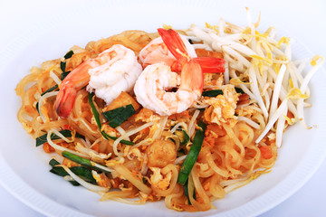 Fried noodle Thai style with prawns, Stir fry noodles with shrimp in padthai style on table. Front view isolate white , brown background