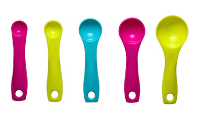 Colored plastic spoons with different volume for loose products