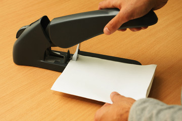 binding papers with stapler by both hands