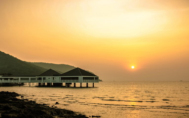 Bungalow near the sea with sunset