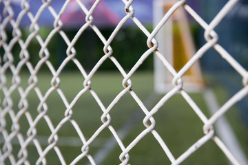 Fototapeta premium white metal grate fence texture and sport field background