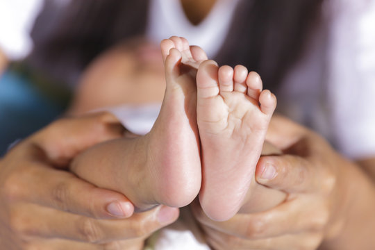 Newborn baby foot in mother hands