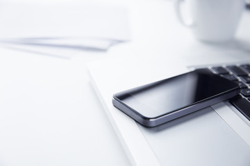 Phone resting on a Laptop Computer