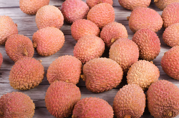 Tasty litchi exotic fruits on wooden background