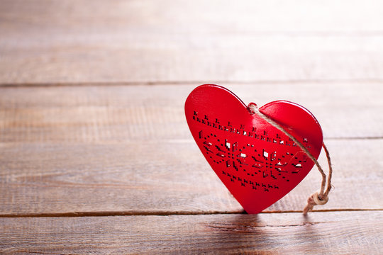 Red heart on wooden background. Symbol of love in valentine's day.