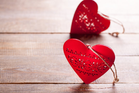 Red hearts on wooden background. Symbol of love in valentine's day.