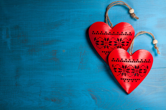 Red hearts on blue wooden background. Symbol of love in valentine's day.