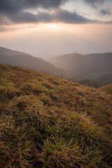 beautiful sunset on the mountain with green field at doi monjong