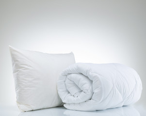 Fototapeta na wymiar Quilt and pillow on the white background