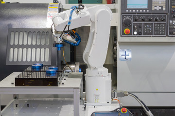 Mechanical hand robot working with CNC lathe machine