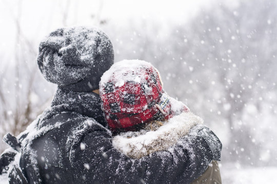 Couple in love outdoors hugging on a winter day